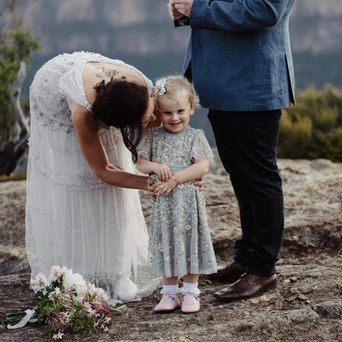 Little Girl with her mum, the bride. Dressed in green flower girl dress wearing our pink tbar leather shoes
