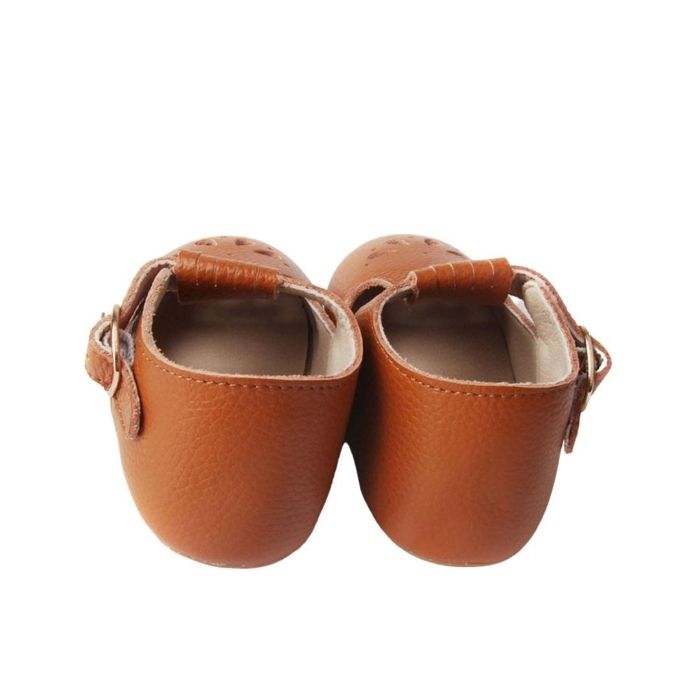 Tan Colored Leather T bars shoes petal cutout details over toe faux buckle rear view