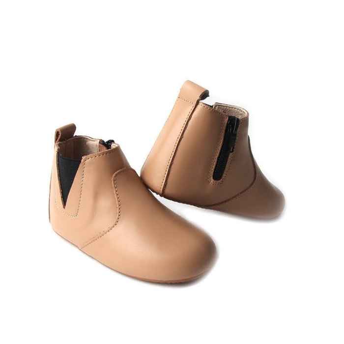 Light brown toddler boots. Pictured heel of one shoe. Stitching detail. Elastic ankle onside. Opposite side zip closure.