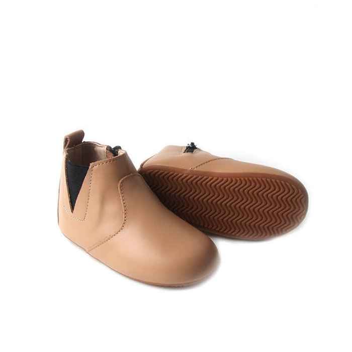 Light tan coloured toddler boot. Image shows flexible rubber sole with grip. Stitching details over the foot. 
