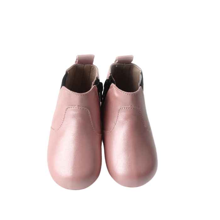 Birdseye view of toddler boots in pink leather. Zip closure. Pull on tab at heal. Detail stiching over top of foot.