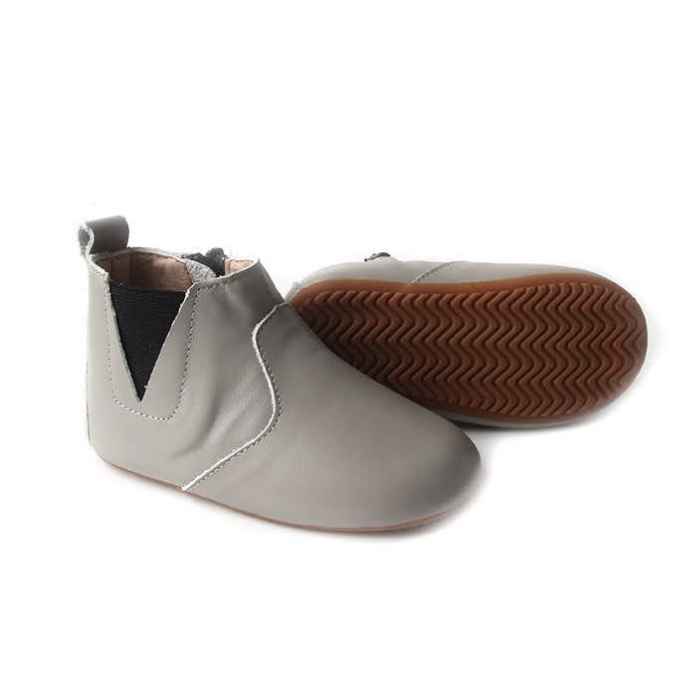 Light grey coloured leather toddler boots. View of the pair from the side. Features elastic ankle closure one side, zip closure opposite side.